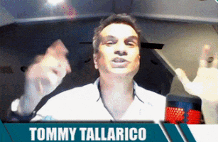 Tommy Tallarico on Screen With Hands in Air