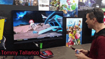 Tommy Tallarico Playing Video Game on Large Screen