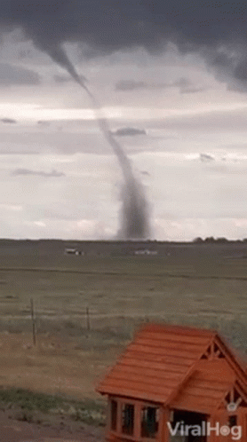 Tornado Moving Through Field With House