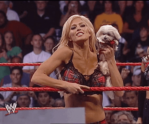 Torrie Wilson Blowing Kisses While Holding Her Dog GIF