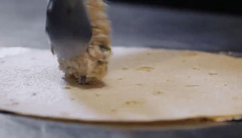 Tortilla Being Rolled with Spoon
