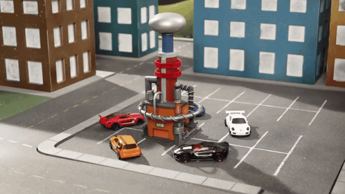 Toy Cars Are Parked In A Parking Lot Next To A Building GIF