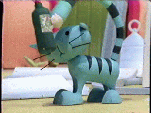 Toy Cat With Bottle on Head