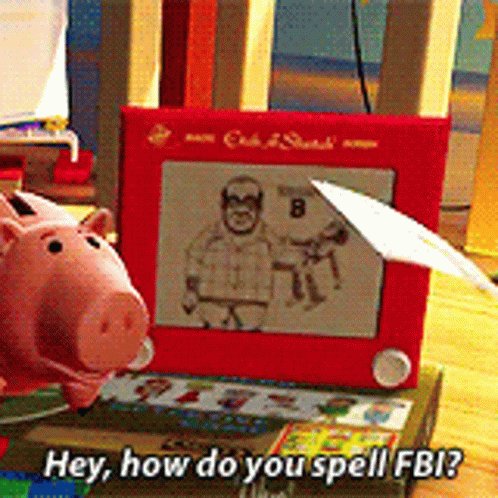 Toy Piggy Bank Next to Etch A Sketch Toy