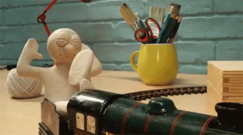 Toy Train Next to Cup of Pencils