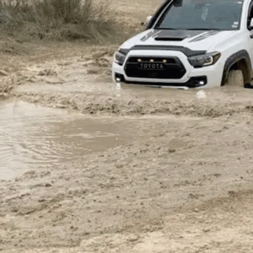 Toyota Tacoma Driving Through Muddy Puddle GIF