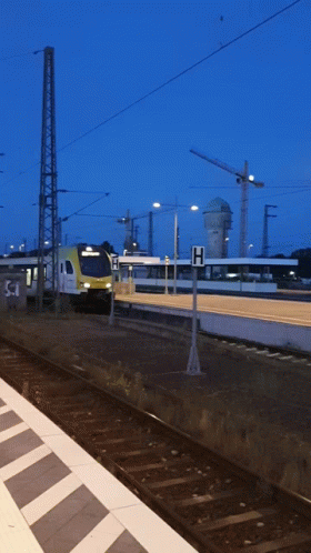 Train Pulling Into Station With H Sign GIF