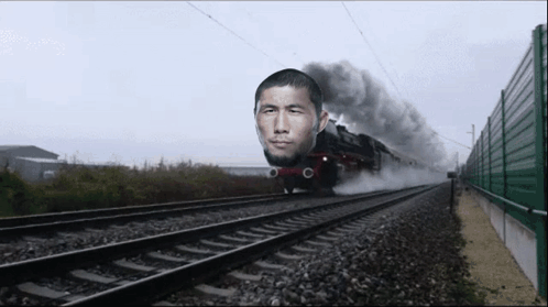 Train With Man Face Going Down Tracks GIF