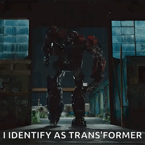 Transformer Robot Standing in Dark Room Says I Identify As Transformer