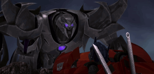 Transformer With Purple Eyes Next to Red Vehicle