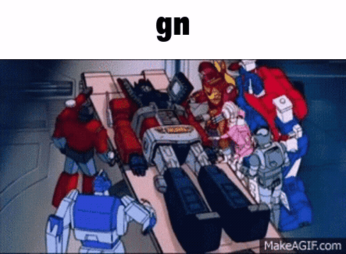 Transformers Gathered Around Table With GN Above Them