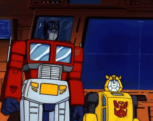 Transformers Optimus Prime and Bumblebee Standing Next to Each Other