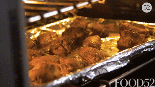 Tray Of Food In Oven With Number 52 GIF