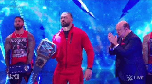 Tribal Chief Wearing Red Suit Raising Belt GIF