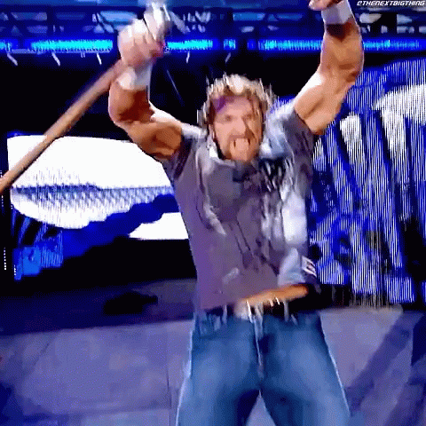 Triple H Flexing Muscle While Holding Sledgehammer GIF