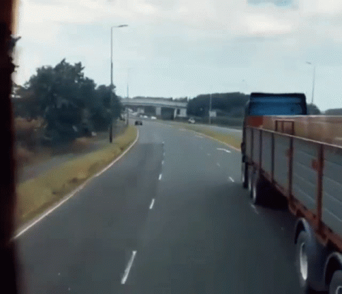 Truck Driving on Highway Next to Car