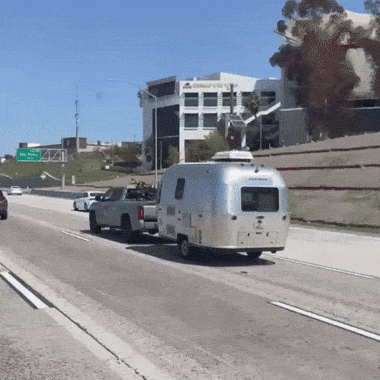 Truck Pulling Airstream Trailer on Freeway