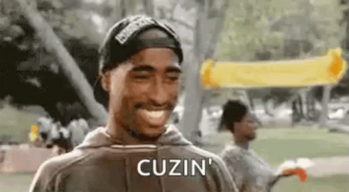 Tupac Shakur Smiling With Hat And Hoodie GIF