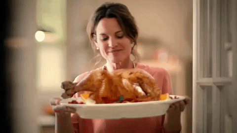 Turkey Day Woman Holding Roasted Bird GIF