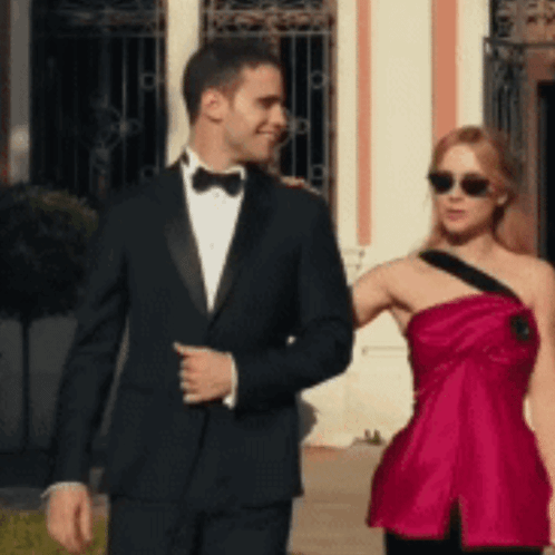 Tuxedo Man and Red Dress Woman Walking