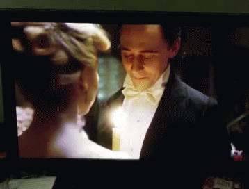 Tuxedo Man Holds Candle With White Dress Woman