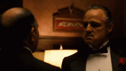 Tuxedo Man Talking to Another by Sign A