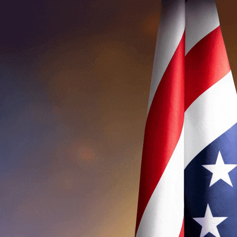 Two American Flags Are Displayed In Front Of A Dark Background GIF