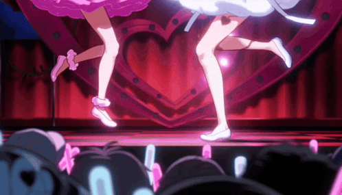 Two Anime Girls Dancing on Stage with Heart Sign