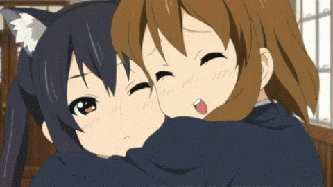 Two Anime Girls Hugging Each Other And One Has A Cat Ear On Her Head GIF