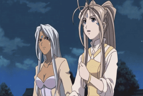 Two Anime Girls Standing Next To Each Other With One Having A Blue Circle On Her Forehead GIF
