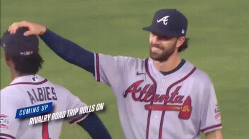 Two Atlanta Braves Baseball Players Are Hugging Each Other GIF