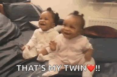 Two Baby Girls Sitting and Laughing
