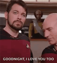Two Bald Bearded Men Talking on Ship