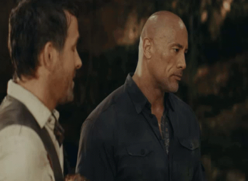 Two Bald Men Are Standing Next To Each Other GIF