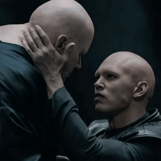 Two Bald Men One Holding Other's Neck