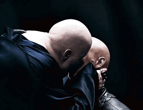 Two Bald Men Touching Each Other's Faces