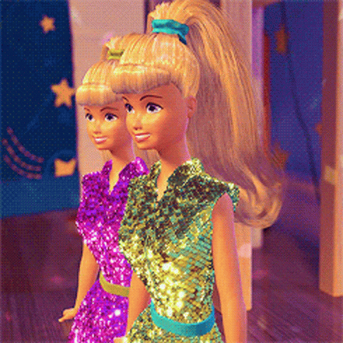 Two Barbie Dolls Are Standing Next To Each Other Wearing Different Dresses GIF