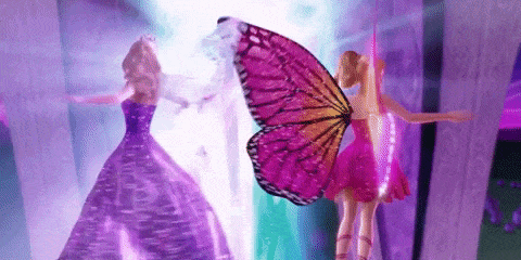Two Barbie Dolls Next to Butterfly Wing
