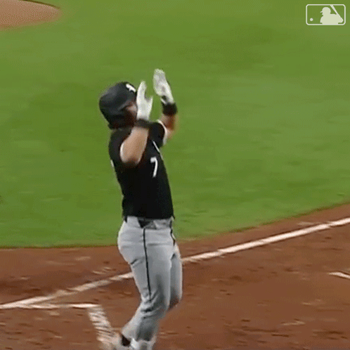 Two Baseball Players Are Celebrating A Home Run On A Baseball Field GIF