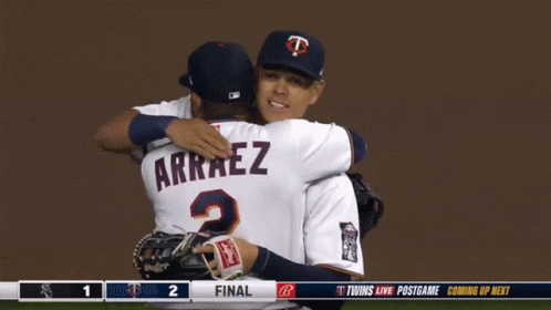Two Baseball Players Are Hugging Each Other And One Has Arraez On His Jersey GIF