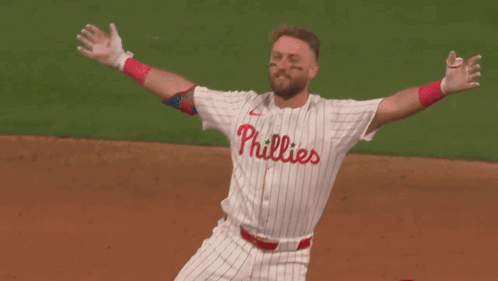 Two Baseball Players Are Hugging Each Other And One Of Them Has The Number 12 On His Jersey GIF