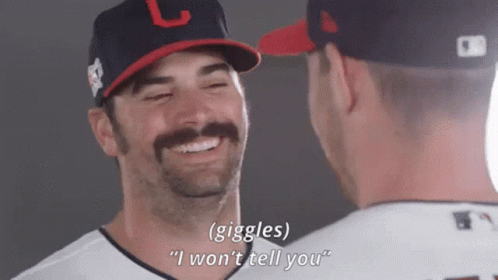 Two Baseball Players Are Laughing And One Of Them Is Wearing A Hat With The Letter L On It GIF