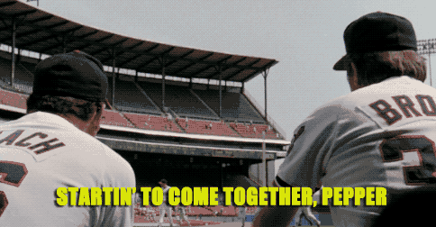 Two Baseball Players Are Standing In Front Of A Stadium With The Words Startin To Come Together Pepper Above Them GIF