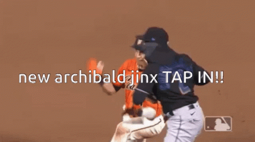 two baseball players are standing on a field with the words new archibald jinx tap in .