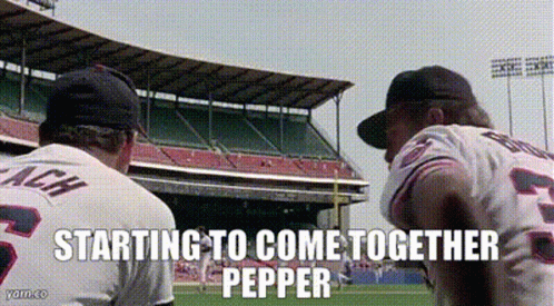 Two Baseball Players Are Standing On A Field With The Words Starting To Come Together Pepper GIF