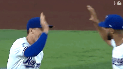 Two Baseball Players High Fiving
