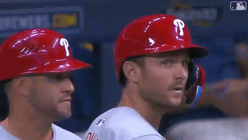 Two Baseball Players in Red Helmets with P