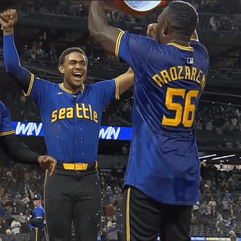 Two Baseball Players in Seattle Jerseys Celebrating