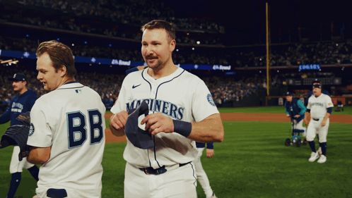 Two Baseball Players One Of Whom Is Wearing A Jersey That Says Bb GIF