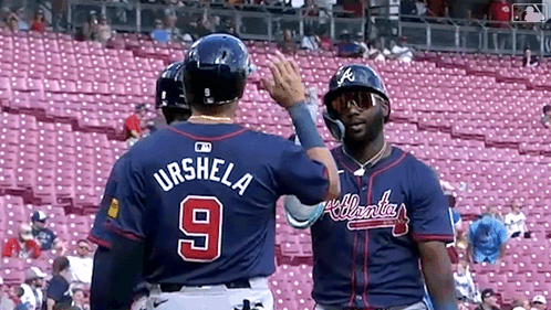Two Baseball Players Standing Next To Each Other GIF